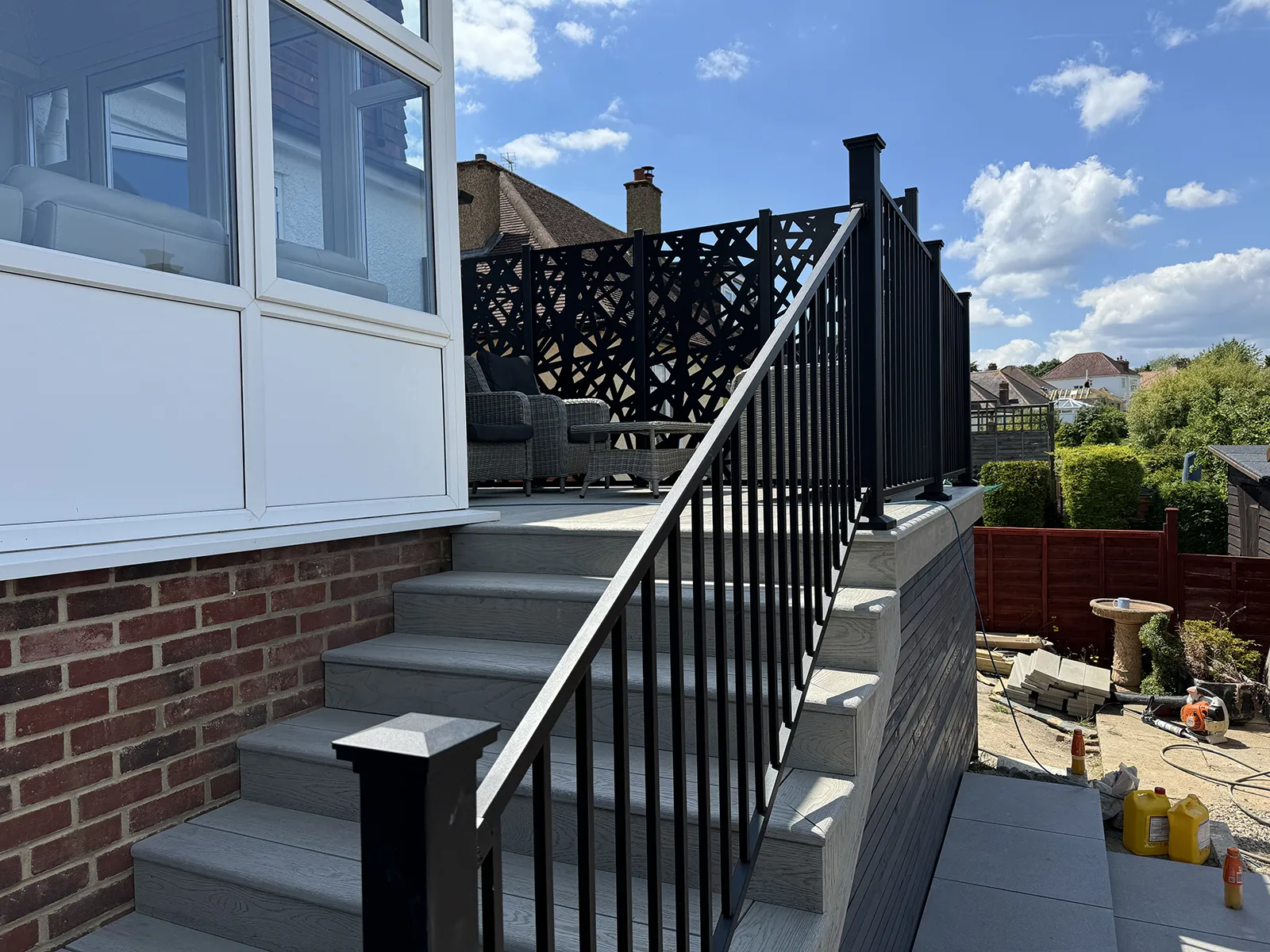 Decorative privacy screens allowing light onto a raised Millboard deck